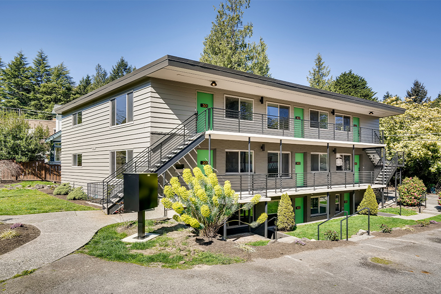 exterior of Maggie apartments with Magnolia neighborhood greenery