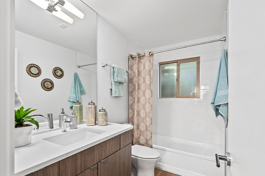 bathroom interior with shower, tub, and granite countertops