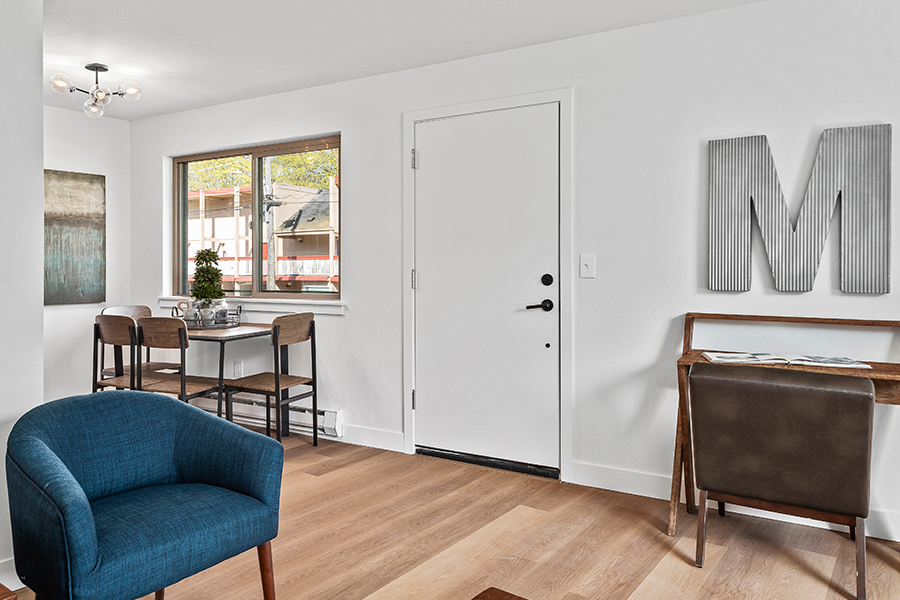 living room interior with desk, chairs, and dining table